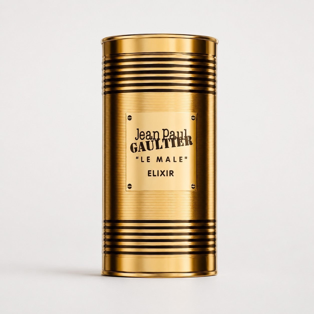 Envase cilíndrico dorado de perfume Jean Paul Gaultier Le Male Elixir de Ricky Luxury con diseño de lata metálica